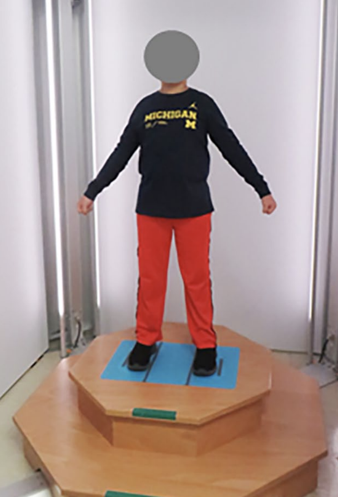 Child in Michigan clothing in a 3d scanner